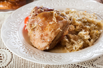 Pork knuckle with fried sauerkraut and tomatoes