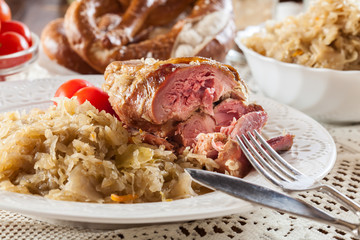 Pork knuckle with fried sauerkraut and tomatoes