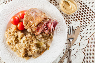 Pork knuckle with fried sauerkraut and tomatoes