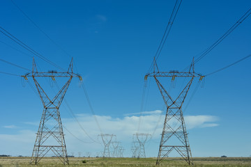 Electric power lines against blue sky