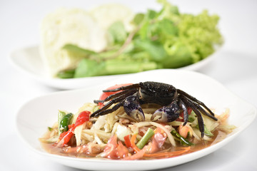Traditional thai cuisine spicy green papaya salad on white background