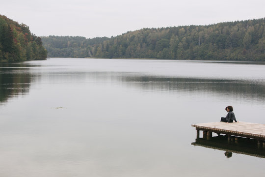 Woman sitting on pier