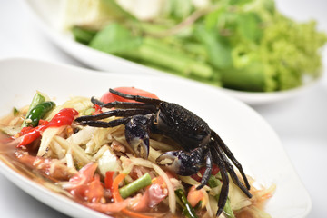 Traditional thai cuisine spicy green papaya salad on white background