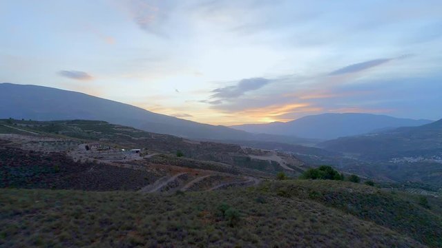 Sunset Over A Mountainous Landscape in Spain with Remote Farms and Houses 