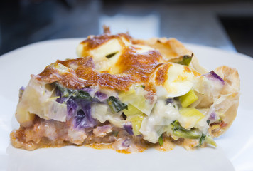 Quiche with vegetables, egg, bacon, chicken and cheese