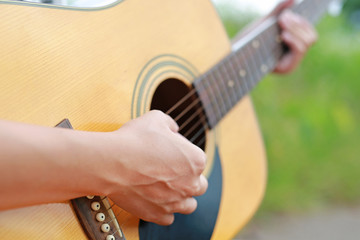 Fototapeta premium Close-up male hands playing on acoustic guitar.