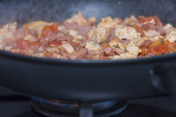 Cooking bacon, tomatoes and chicken