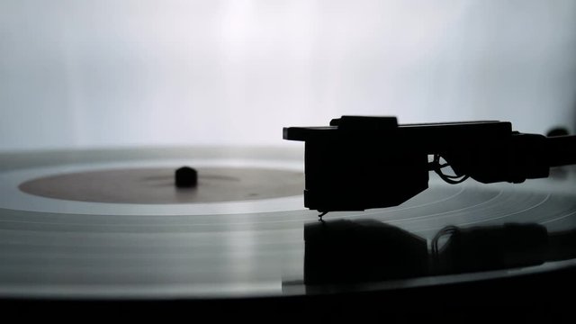 Spinning Record Player With Vintage Vinyl. Turntable Player And Vinyl Record With Dropping Stylus Needle Running Old CD And Playing Music on White Background