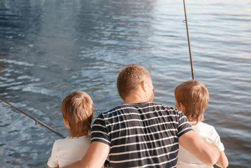 Father with sons fishing on river © Africa Studio