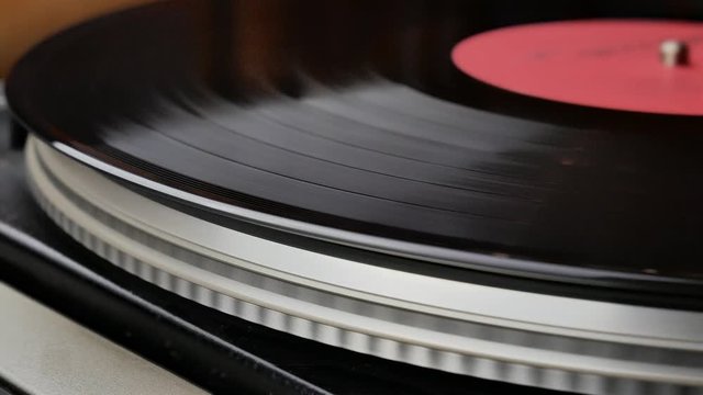 Spinning Record Player With Vintage Vinyl. Turntable Player And Vinyl Record With Dropping Stylus Needle Running Old CD And Playing Music on White Background