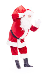 Portrait of Christmas character Santa Claus in traditional costume with red sack on white background