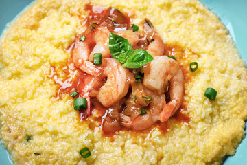 Fresh tasty shrimp and grits on plate, closeup