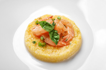 Fresh tasty shrimp and grits on plate, closeup