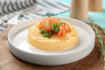 Plate with fresh tasty shrimp and grits on table, closeup