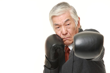 senior Japanese businessman throwing a left jab