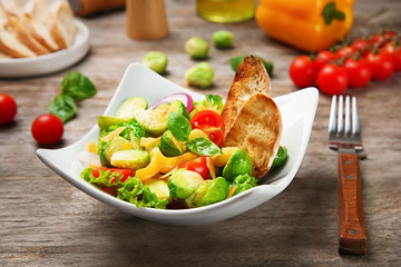 Plate of salad with Brussels sprouts on table