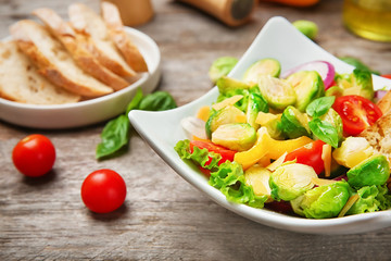 Plate of salad with Brussels sprouts on table