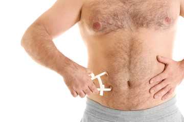 Overweight man with caliper on white background