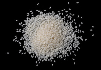 White rice pile isolated on black background, top view