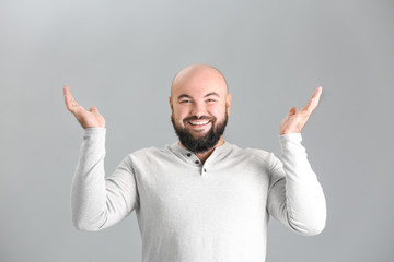 Fototapeta premium Overweight young man on light background