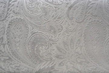 Gray or silver velvet fabric with a vintage elegant floral pattern or a luxury texture.