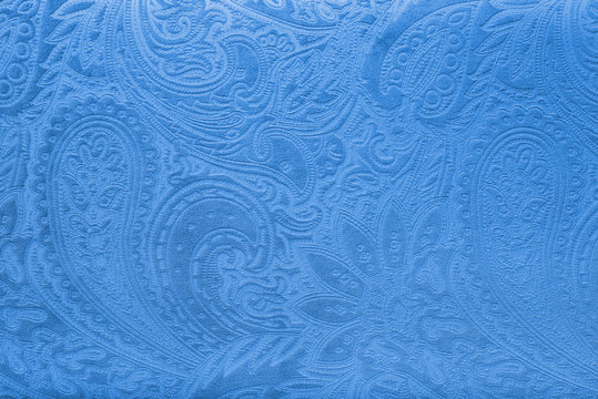 Blue velvet fabric with a vintage elegant floral pattern or a luxury texture.