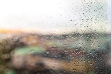 Looking at the city through rainy window