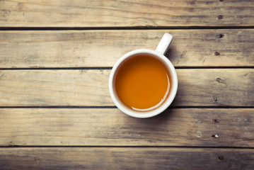 Cup with green tea on grey wooden background