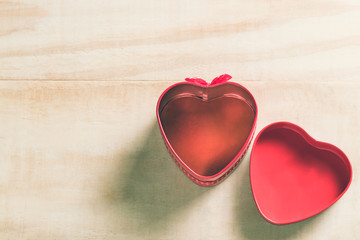 Valentine's day background with open  empty heart shape box on wooden table. top view