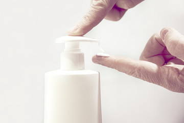 Old person hands using some cream for skin health care. Empty copy space for Editor's text.