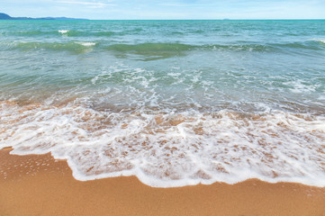 Beautiful white soft wave on empty tropical beach and blue sea 