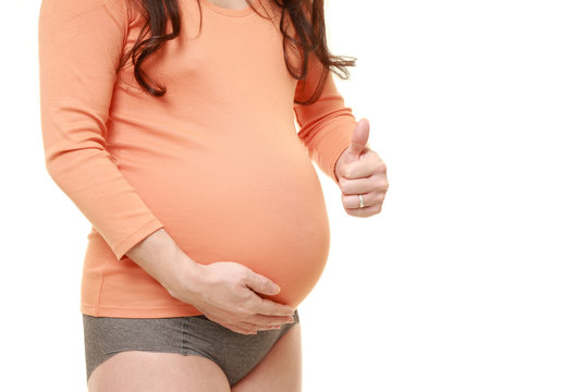 pregnant woman wearing orange shirt with thumbs up gesture　
