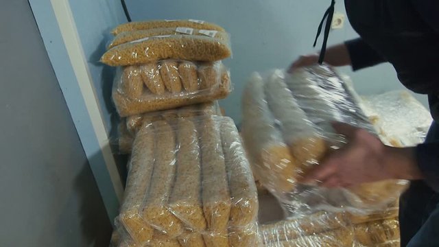 Worker stacking spaghetti bags