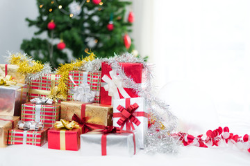 Gift box with Christmas tree background for surprise Children in New year or Xmas party festival. Relaxing holiday and Object concept. Christmas party event and Happy new year theme. Decorate property