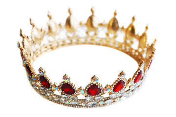 Golden crown with precious stones. Gold, sapphires and diamonds, red and white jewelry. Decoration for king or queen, magic crown isolated on white background, close up