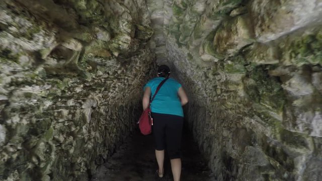 Woman in ancient Mayan tunnel at Coba