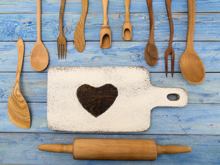 wooden kitchen accessories on a blue wooden background. 