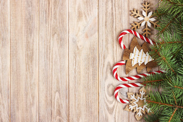 Christmas candy canes and snowflakes on a wooden background