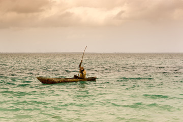 Unrecognizable local fisherman on a traditional boat in Kendwa, Zanzibar island, Tanzania Africa