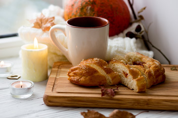 Cup of tea and bread near the window. Lifestyle of the autumn. Pumpkin