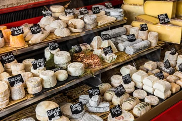 Fotobehang Different cheeses on the counter of a small store at the Aligre Market. Paris, France © Aliaksandr Kazlou