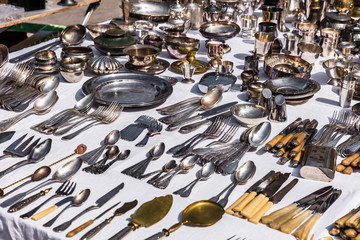 Vintage silver cutlery and tableware at a garage sale at the flea market in Paris. France