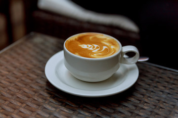 Coffee cup on wood texture and background with space.