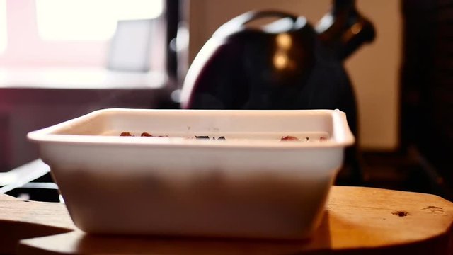 The process of preparing instant noodles with spices, vegetables, and meat. Slow motion of pouring boiling water into the instant noodles, stirs instant noodles with a fork.