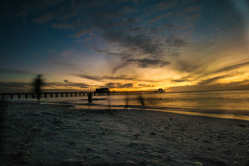 Moody Sunset at Naples Beach Pier - 182855322