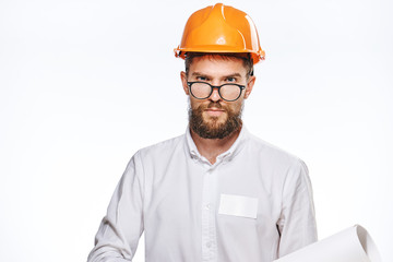 Engineer with a beard on a white isolated background holds a drawing