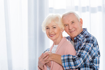 portrait of happy senior couple looking at camera