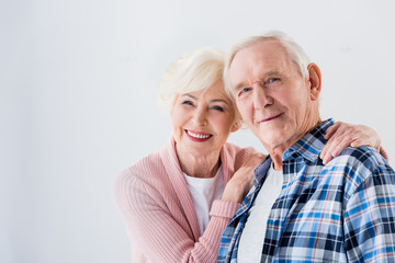 portrait of happy senior couple looking at camera