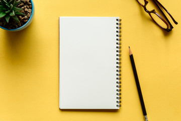 Fototapeta na wymiar notebook and pencil on yellow desk