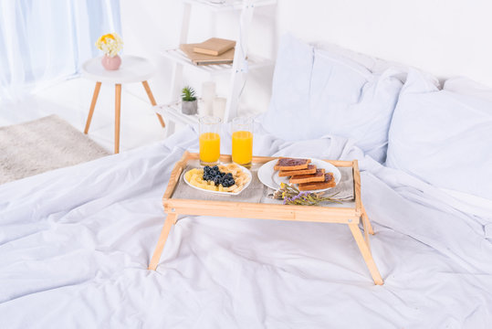 Breakfast In Bed On Wooden Tray At Morning